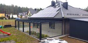 Przesuwna zabudowa tarasu z aluminiową konstrukcją i szklanymi panelami